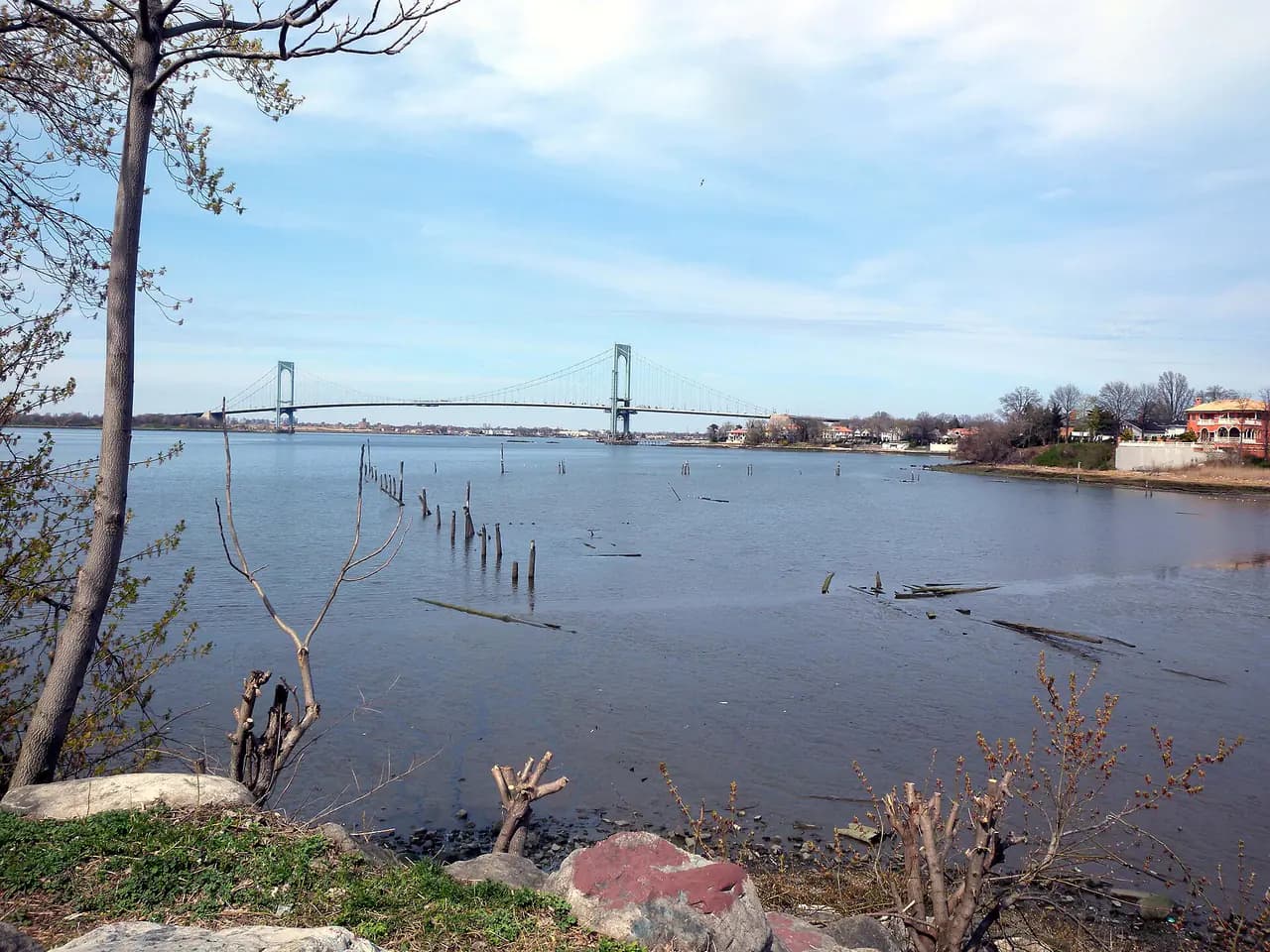 Powell's Cove in College Point, Queens, with the Bronx-Whitestone Bridge in the distance on a cloudy day