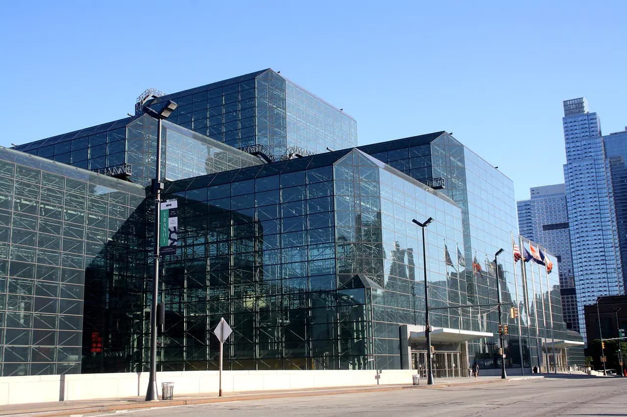 The glass facade of the Jacob K. Javits Convention Center on Manhattan's West Side under a blue sky