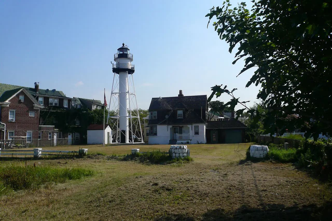 The white iron-frame Coney Island lighthouse beside its shingled keeper's house in Sea Gate, Brooklyn