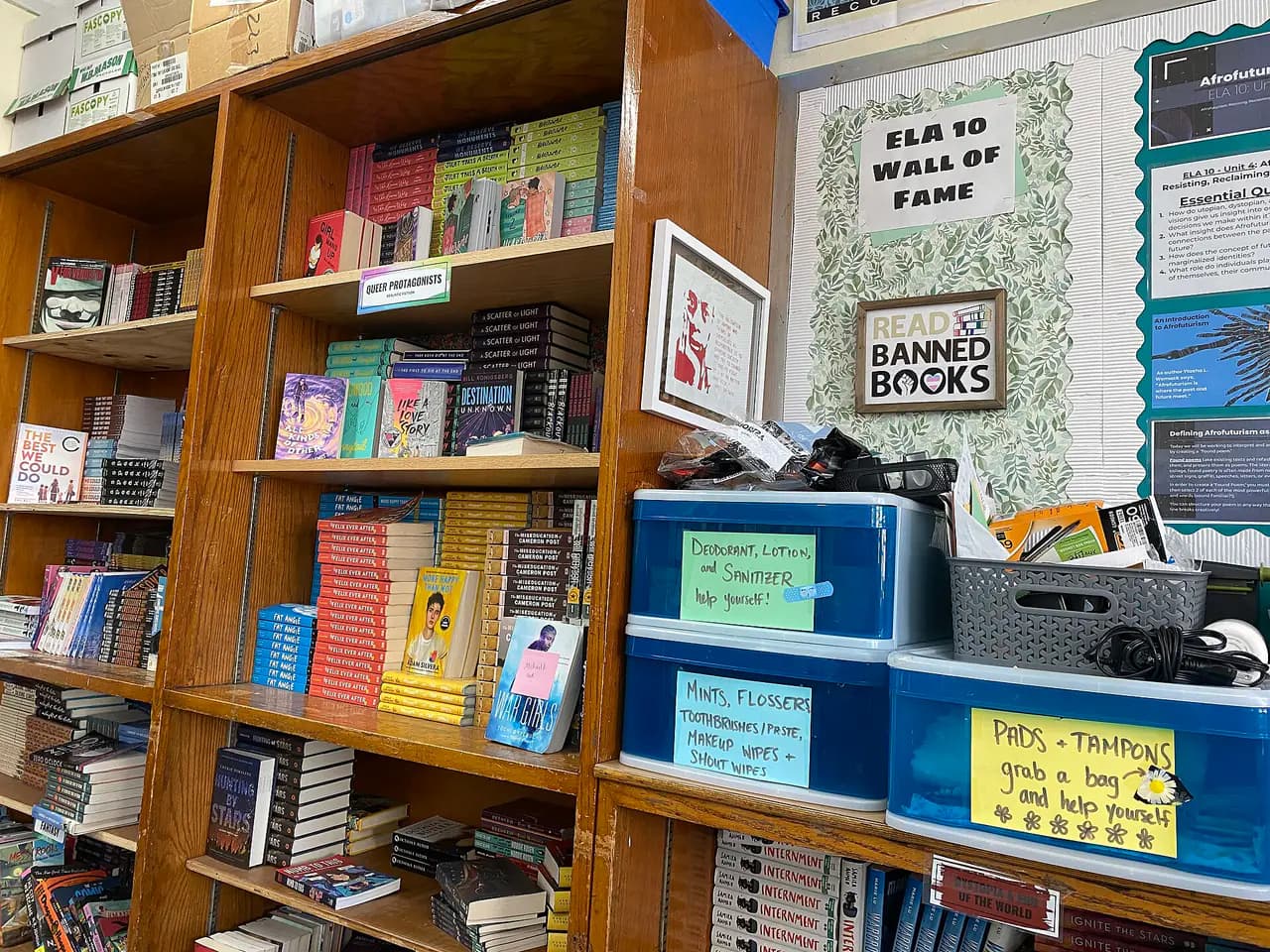 A Bronx public high school classroom with desks, a bookshelf library corner and supplies on a table