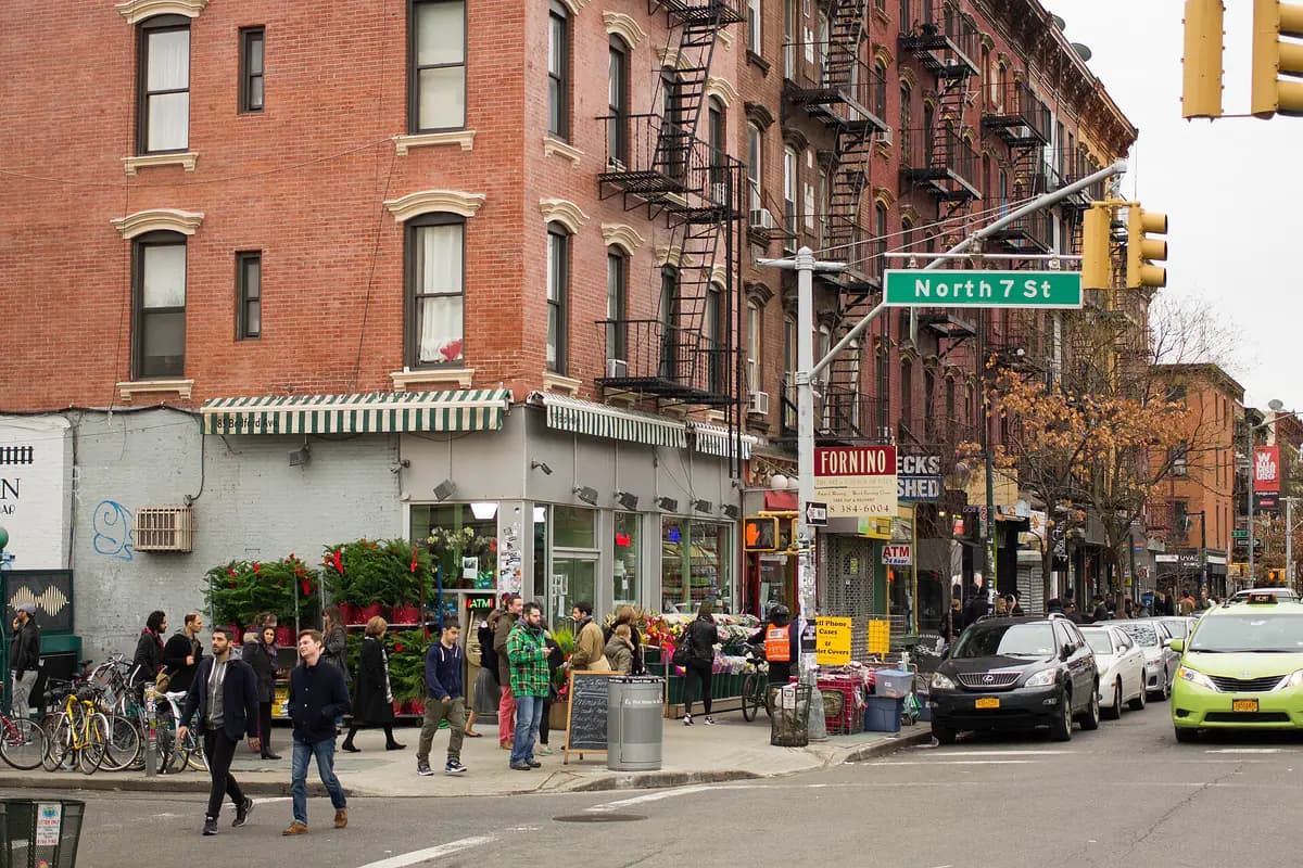 Brick apartment buildings and corner shops at Bedford Avenue and North 7th Street in Williamsburg, Brooklyn
