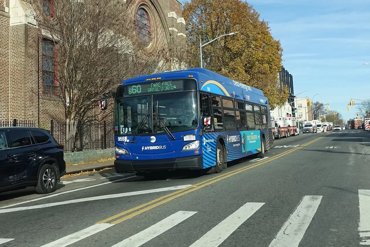A blue MTA B60 bus on Rockaway Avenue at Eastern Parkway in Brooklyn, with a green route sign