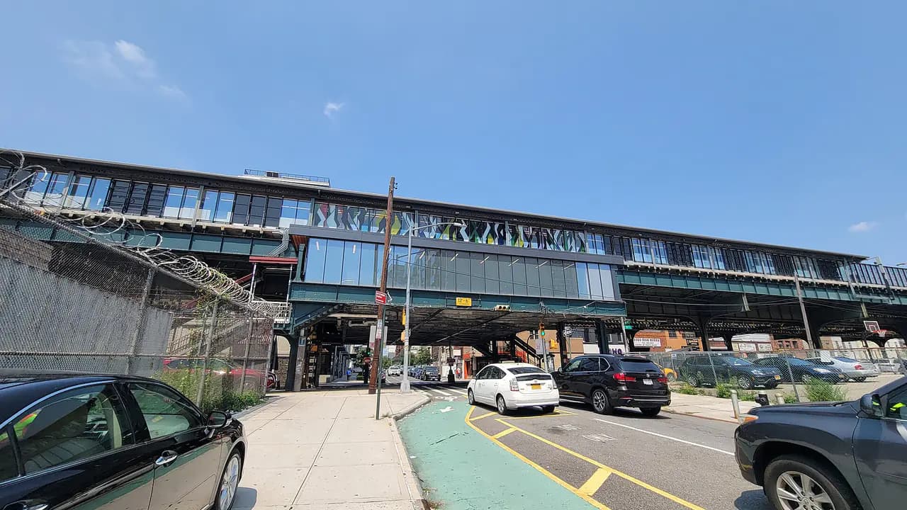 The elevated 39th Avenue-Dutch Kills subway station over a Queens street on a sunny day