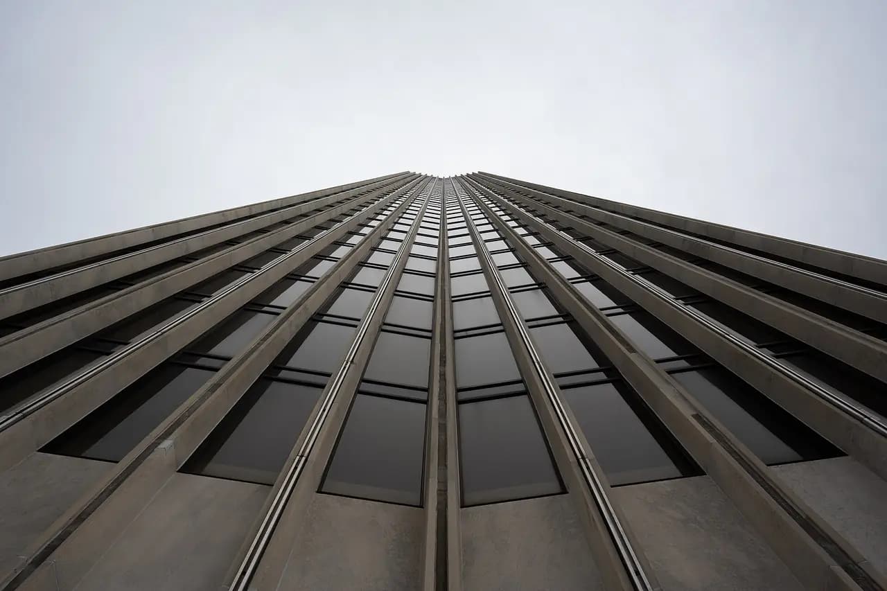 Looking up the stone and glass facade of the Erastus Corning Tower at the Empire State Plaza in Albany