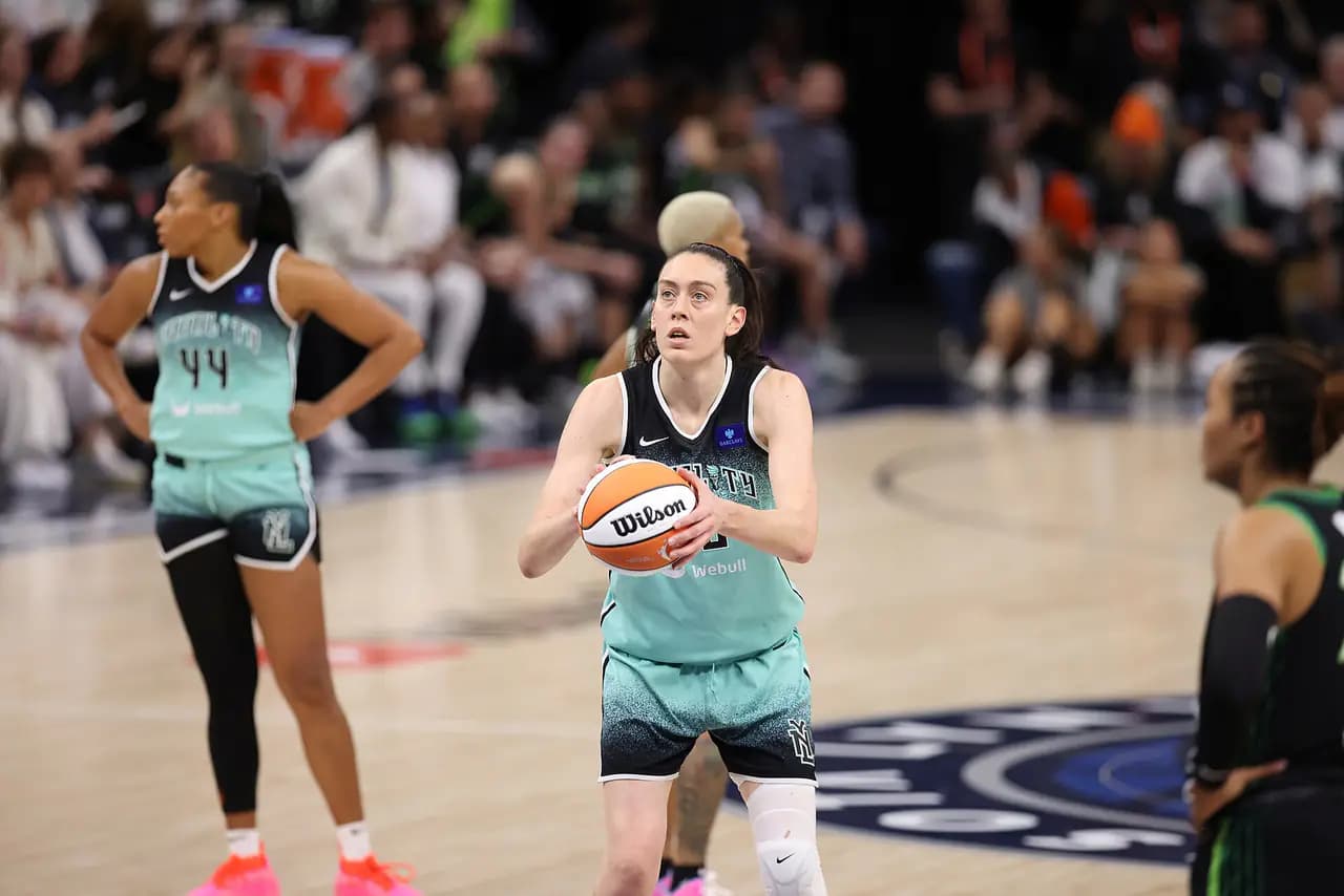 Liberty forward Breanna Stewart, in a mint-green road uniform, holds the ball at the free-throw line during a WNBA Finals game