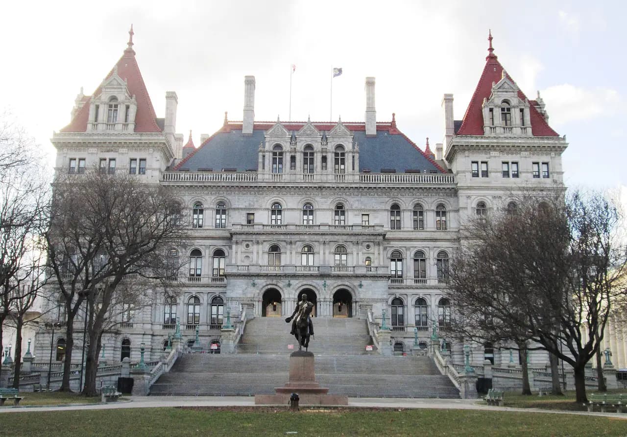 The southeast facade of the New York State Capitol in Albany, a granite building with towers and a wide staircase