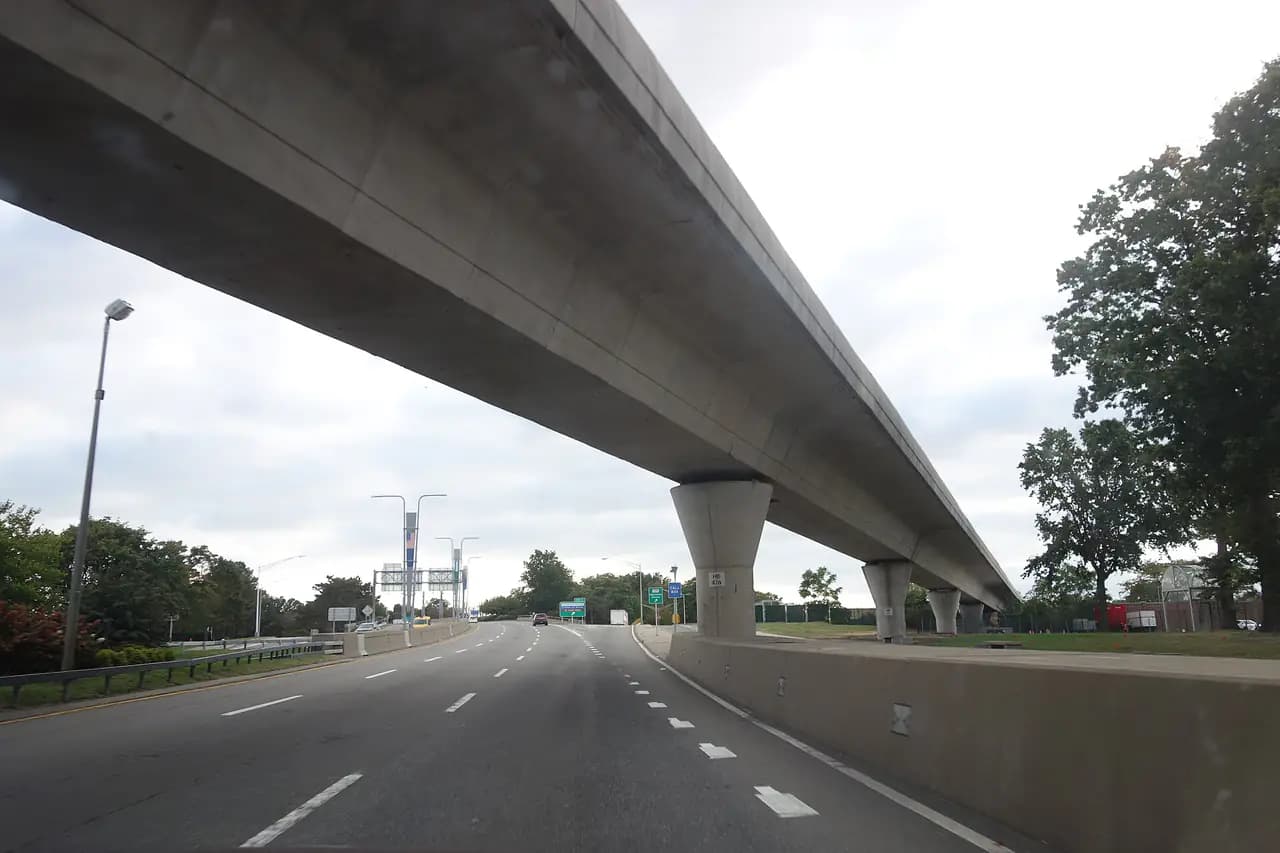 The Van Wyck Expressway running south toward JFK Airport beneath the elevated AirTrain guideway