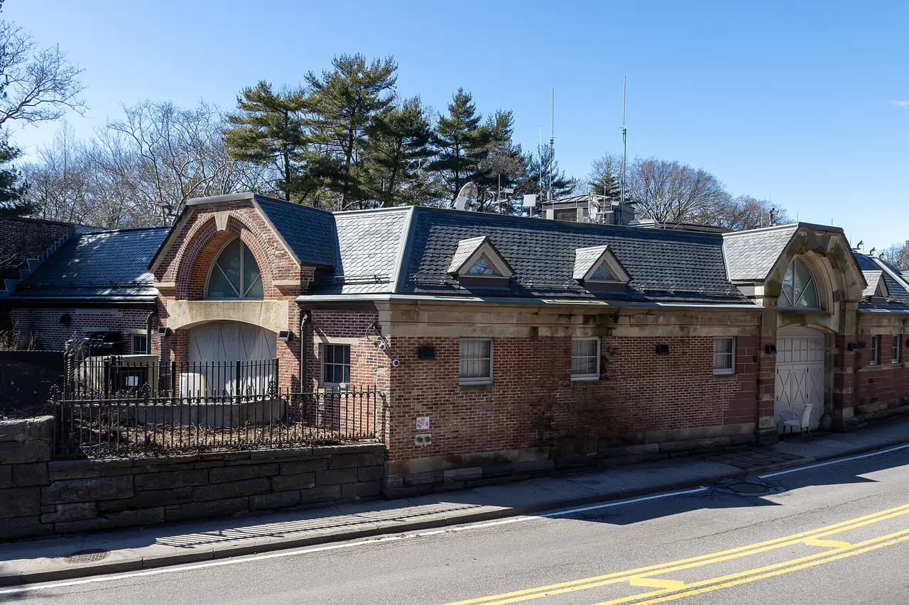 The brick Central Park Precinct station house with slate roofs along the 86th Street Transverse