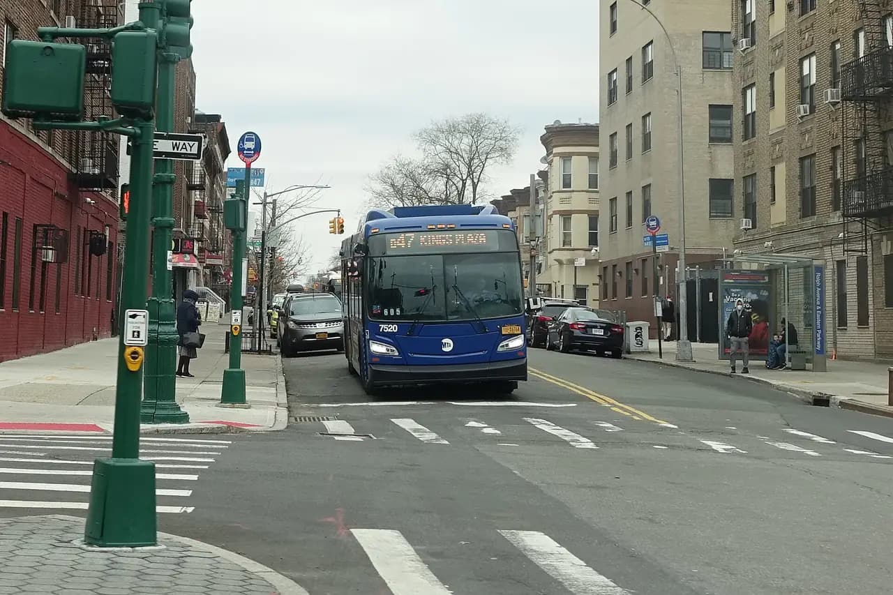 A B47 bus waits at a light at Ralph Avenue and Eastern Parkway on the Crown Heights–Brownsville border in Brooklyn
