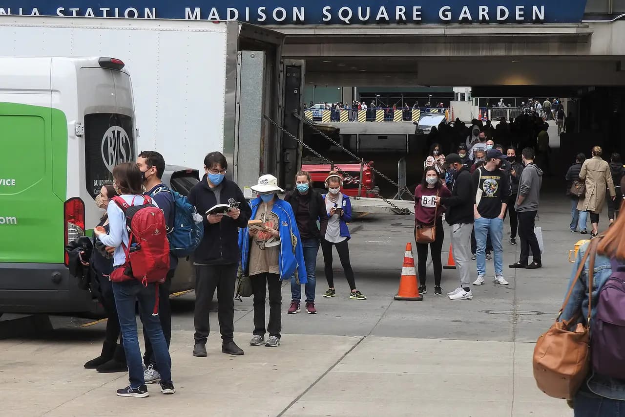 Voters wait in a long line outside the Madison Square Garden early voting site on a fall morning