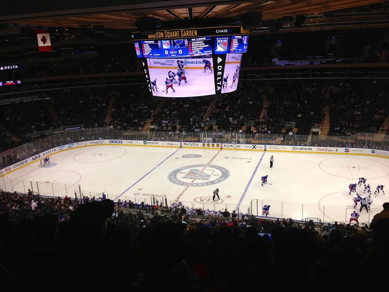 The arena bowl of Madison Square Garden during a New York Rangers hockey game, seen from the upper seats