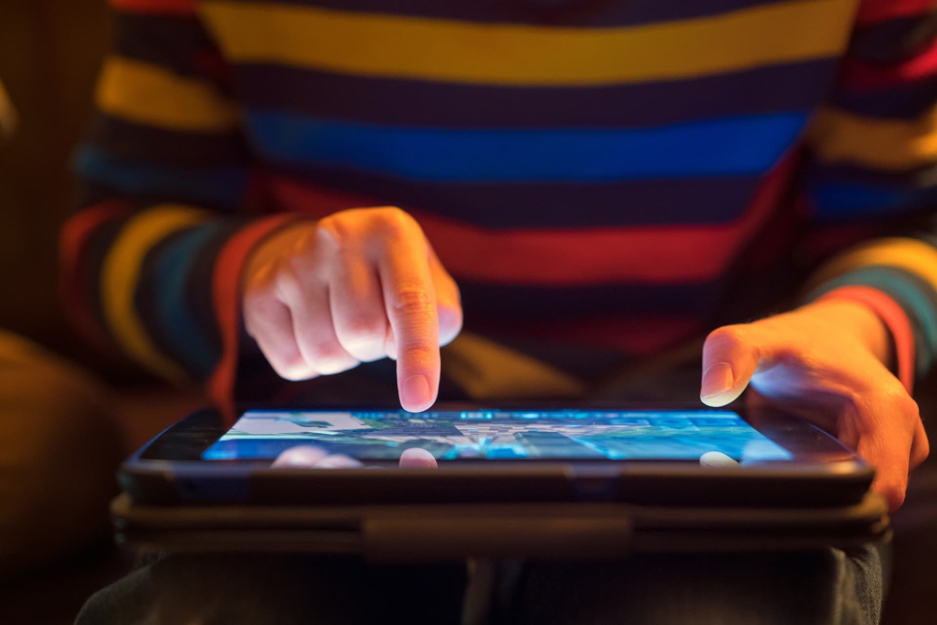 Stock photo of a child using a tablet.